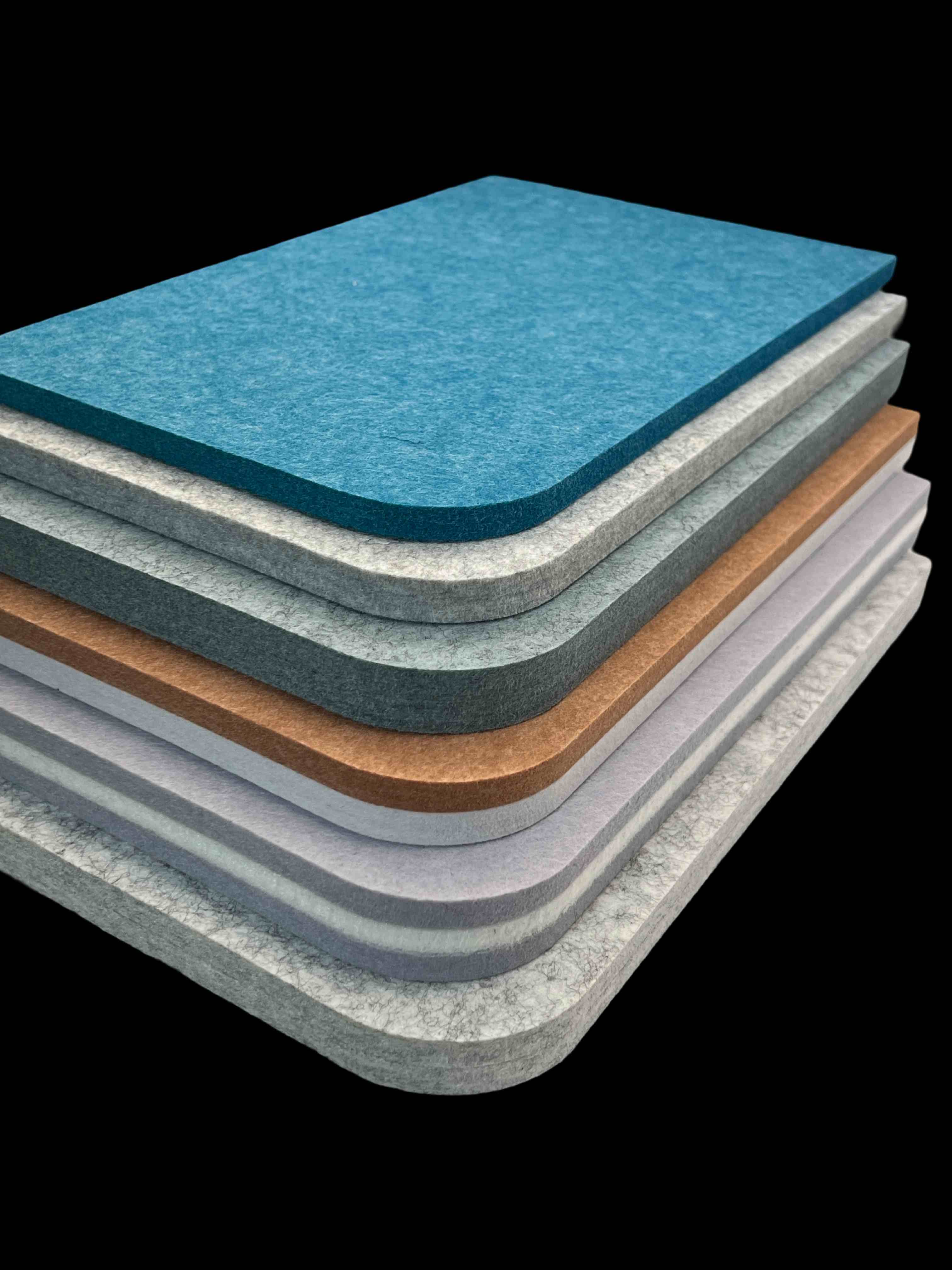 Stacked ÜNO Board acoustic panels in multiple colours
